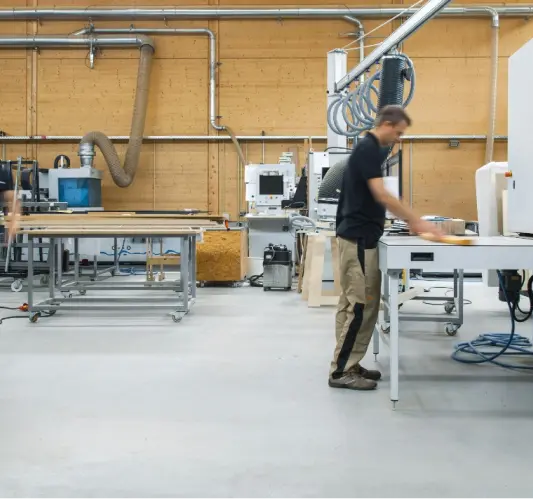 Woodworker in a modern workshop creating handcrafted live edge tables in Ottawa.