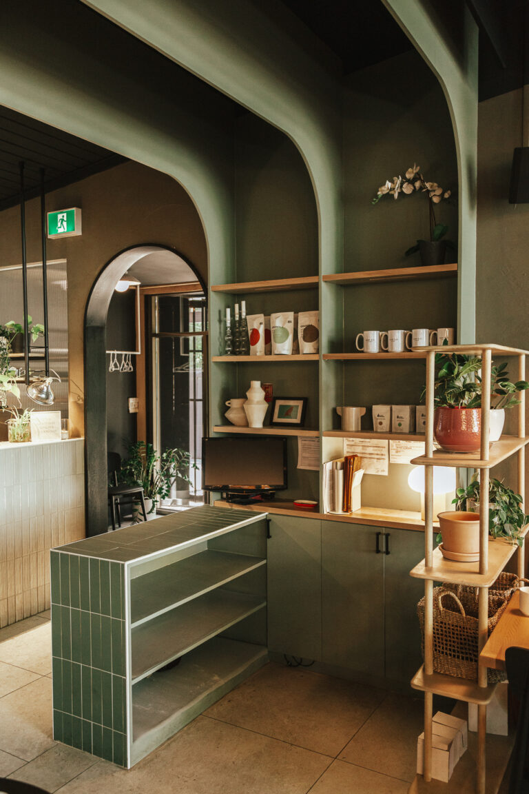 Stylish Ottawa interior with green shelving, plants, and contemporary design elements highlighting custom live edge tables.